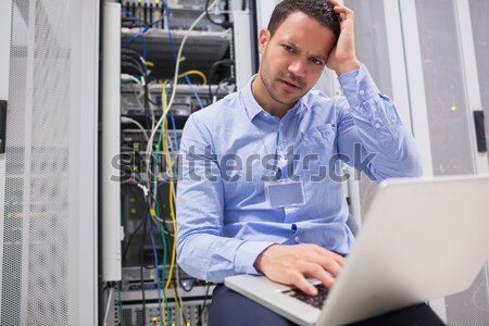 Technician working on personal computer while analyzing server Stock photo © wavebreak_media