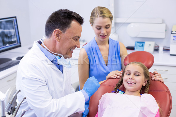 Dentist interacting with young patient Stock photo © wavebreak_media