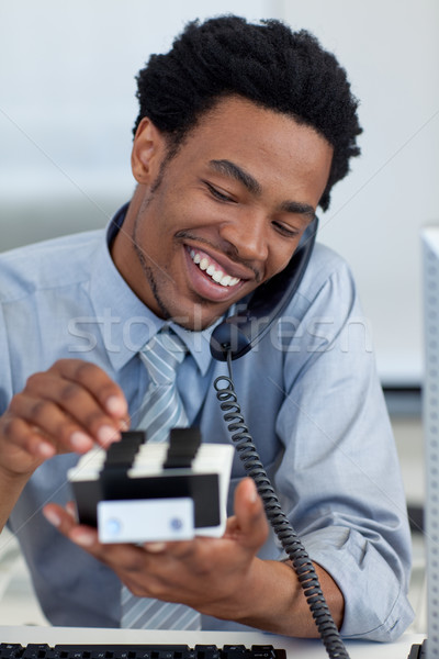 Stock photo: Smiling businessman on phone looking at card holder