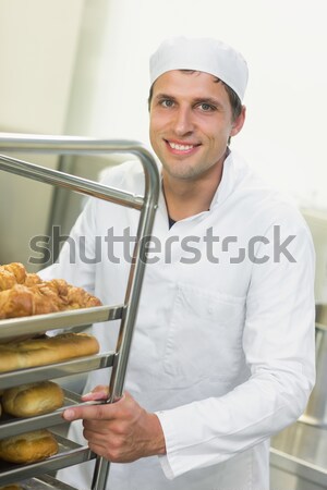 Cheerful female chef baking bread Stock photo © wavebreak_media