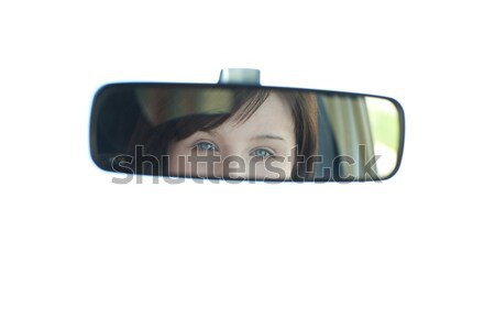 Young woman looking in the rear-view mirror Stock photo © wavebreak_media