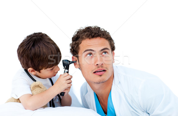 Cute little boy checking doctor's ears Stock photo © wavebreak_media