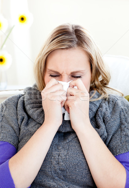 Diseased woman use a handkerchief sitting on a sofa Stock photo © wavebreak_media