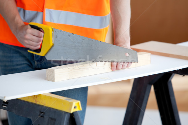 Close-up of a male worker sawing a wooden board Stock photo © wavebreak_media