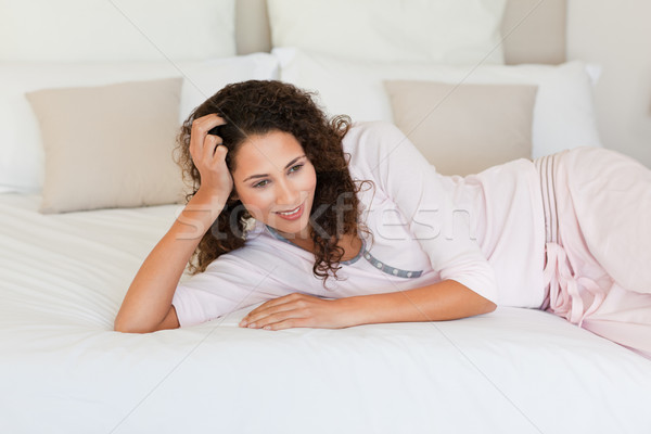 Beautiful woman lying down on her bed at home Stock photo © wavebreak_media