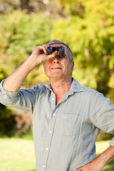 Elderly man looking at the sky with his binoculars Stock photo © wavebreak_media