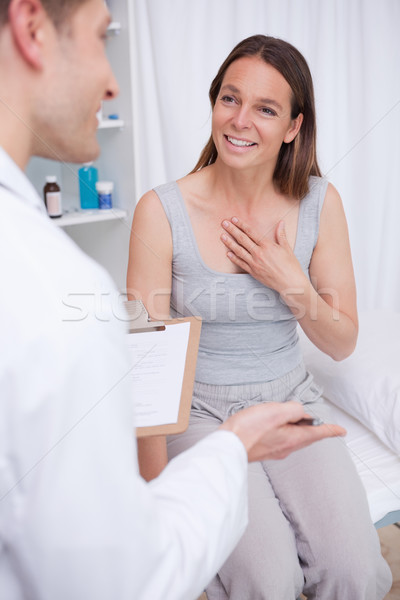 Patient talking to her doctor in examination room Stock photo © wavebreak_media