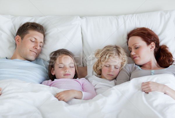 Stock photo: Young family taking a nap together