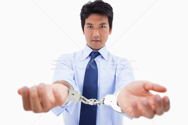 Businessman with handcuffs against a white background Stock photo © wavebreak_media