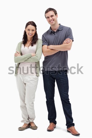 Smiling couple crossing their arms against white background Stock photo © wavebreak_media