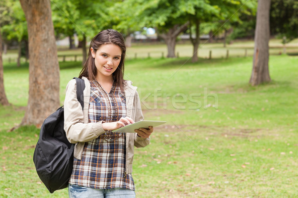 Young student using a tactile tablet in a park Stock photo © wavebreak_media