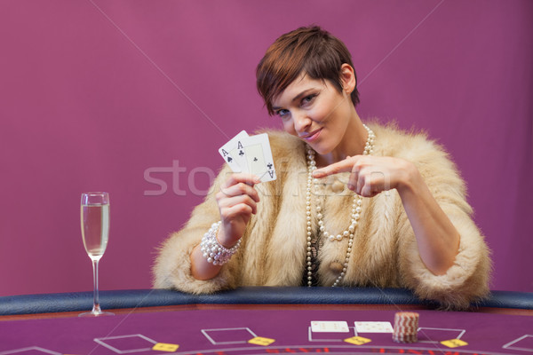 Woman holding up cards in casino Stock photo © wavebreak_media