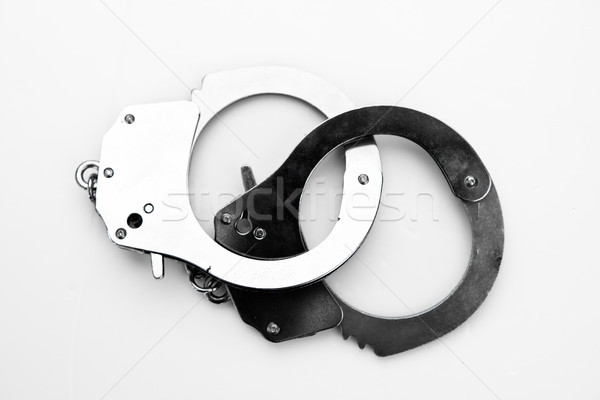 Black and silver handcuffs against white background Stock photo © wavebreak_media