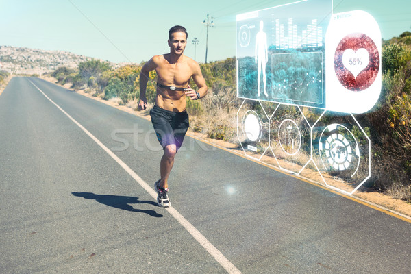 Composite image of athletic man jogging on open road with monito Stock photo © wavebreak_media