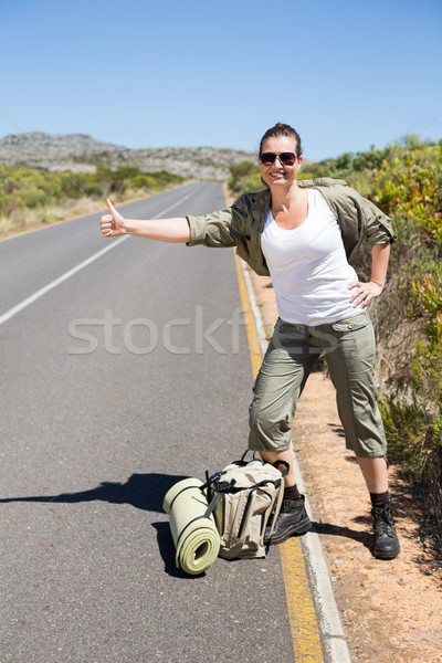 Pretty hitchhiker sticking thumb out on the road Stock photo © wavebreak_media