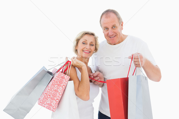 Mosolyog érett pár tart bevásárlótáskák fehér Stock fotó © wavebreak_media