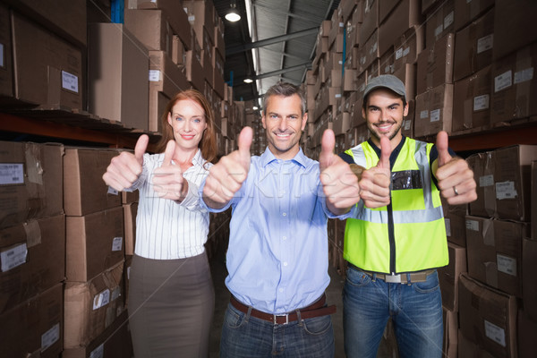 Warehouse team smiling at camera showing thumbs up Stock photo © wavebreak_media