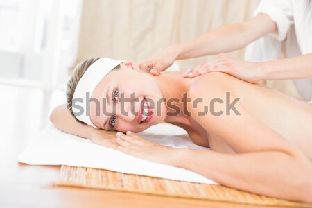 Stock photo: Attractive young woman receiving facial massage at spa center