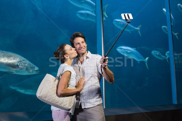 Happy couple using selfie stick Stock photo © wavebreak_media