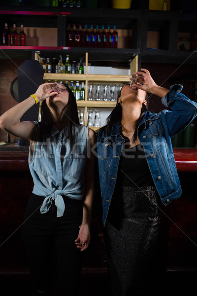 Female friends having tequila shot Stock photo © wavebreak_media
