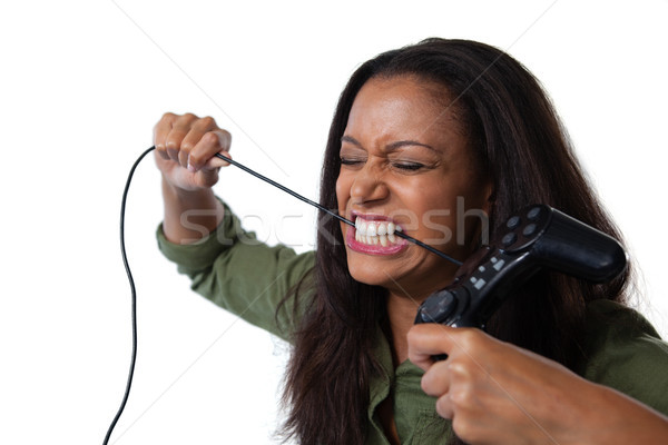 Frustrated woman biting a wire of joystick Stock photo © wavebreak_media