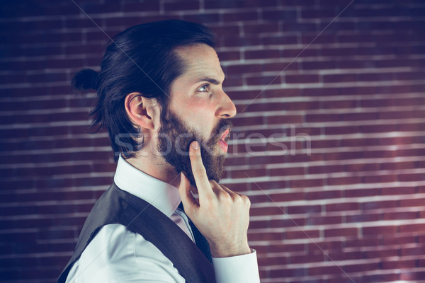 Side view of hipster with hand on chin thinking  Stock photo © wavebreak_media