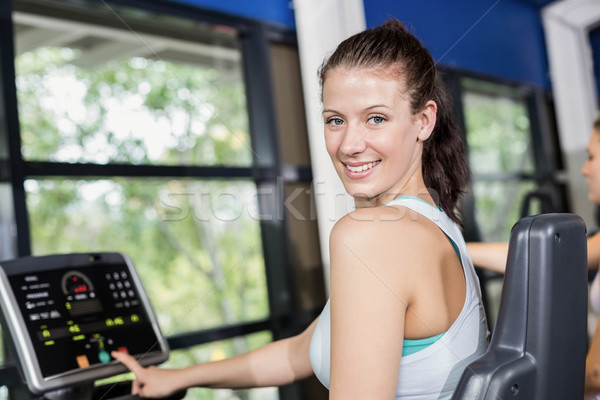 S'adapter femme exercice vélo gymnase heureux [[stock_photo]] © wavebreak_media