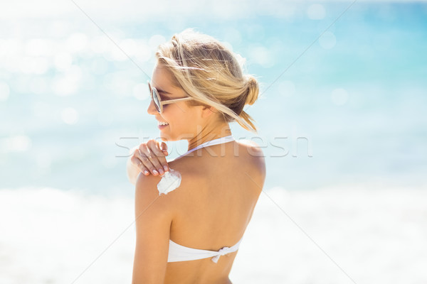 Woman applying sun cream on her shoulder Stock photo © wavebreak_media