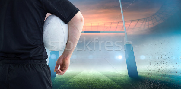 Composite image of rugby player holding a rugby ball Stock photo © wavebreak_media