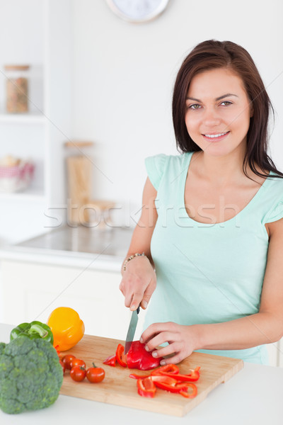 Charmant brunette poivre cuisine femme [[stock_photo]] © wavebreak_media