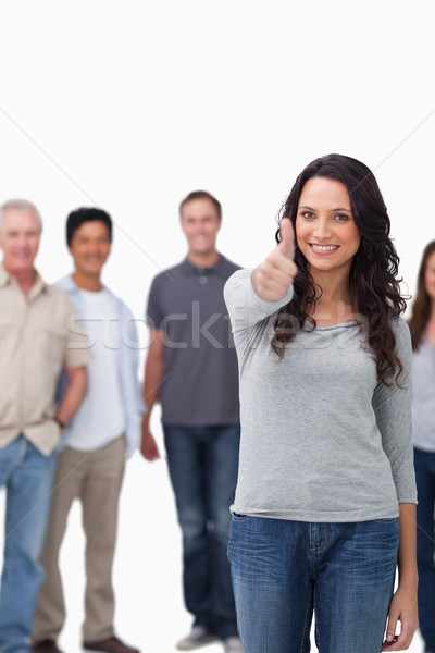 Stockfoto: Glimlachende · vrouw · duim · omhoog · vrienden · achter · witte