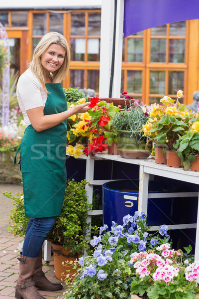 Woman working in garden center handling the flowers Stock photo © wavebreak_media