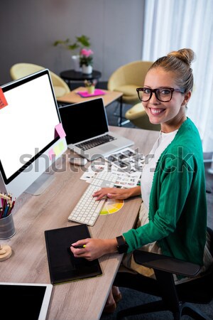 Laughing photo editor working with a graphic tablet Stock photo © wavebreak_media