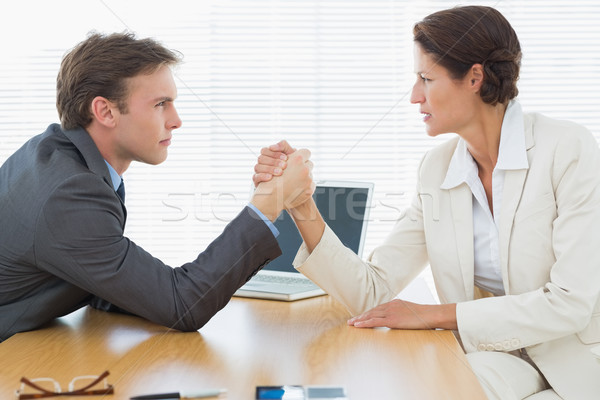 Serious business couple arm wrestling at office desk Stock photo © wavebreak_media
