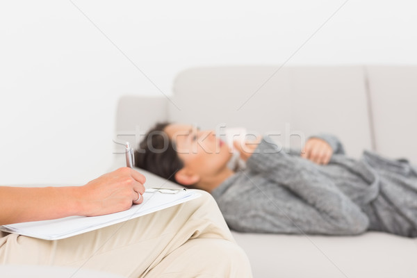 Therapist taking notes on her crying patient on the sofa Stock photo © wavebreak_media