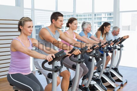 Trainer besides people working out at spinning class Stock photo © wavebreak_media