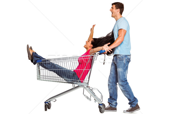 Young couple having fun with shopping cart Stock photo © wavebreak_media