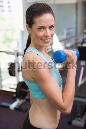 Fit brunette working out with dumbbells  Stock photo © wavebreak_media