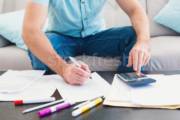 Stock photo: A man counting his bills at home
