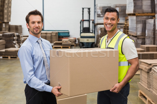 Warehouse worker and manager passing a box Stock photo © wavebreak_media