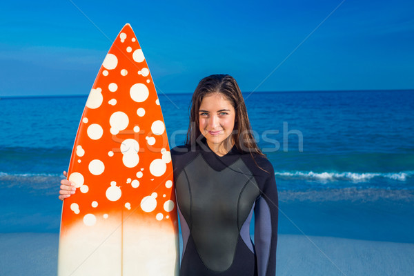Woman in wetsuit with a surfboard on a sunny day Stock photo © wavebreak_media