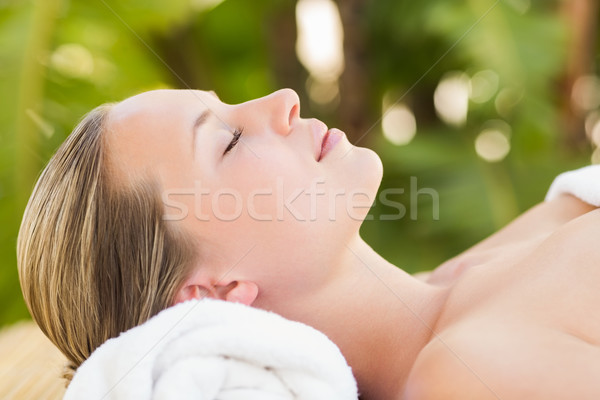 Peaceful blonde lying on towel smiling at camera  Stock photo © wavebreak_media