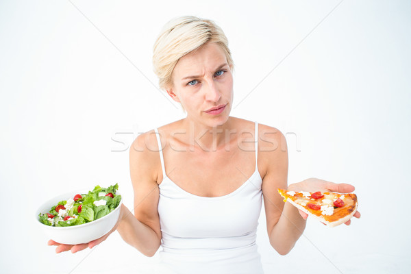 Pretty woman deciding between pizza and salad Stock photo © wavebreak_media