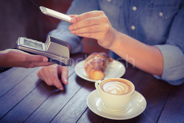 Male customer paying with smartphone Stock photo © wavebreak_media