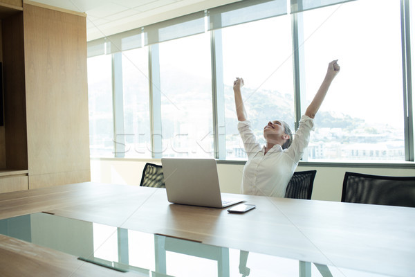 Cheerful businesswoman sitting in conference room Stock photo © wavebreak_media