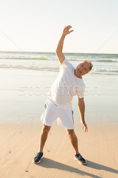 Stock photo: Portrait of happy man exercising at beach