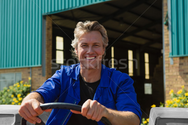 Smiling worker driving a tractor Stock photo © wavebreak_media