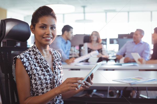 Portrait of businesswoman using digital tablet in office Stock photo © wavebreak_media