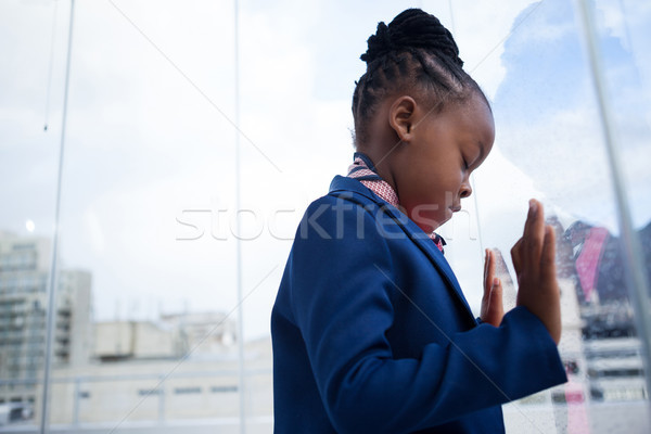Businesswoman with closed eyes standing at window Stock photo © wavebreak_media