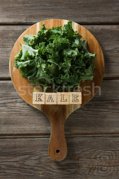 Kale leaves with text on cutting board at table Stock photo © wavebreak_media